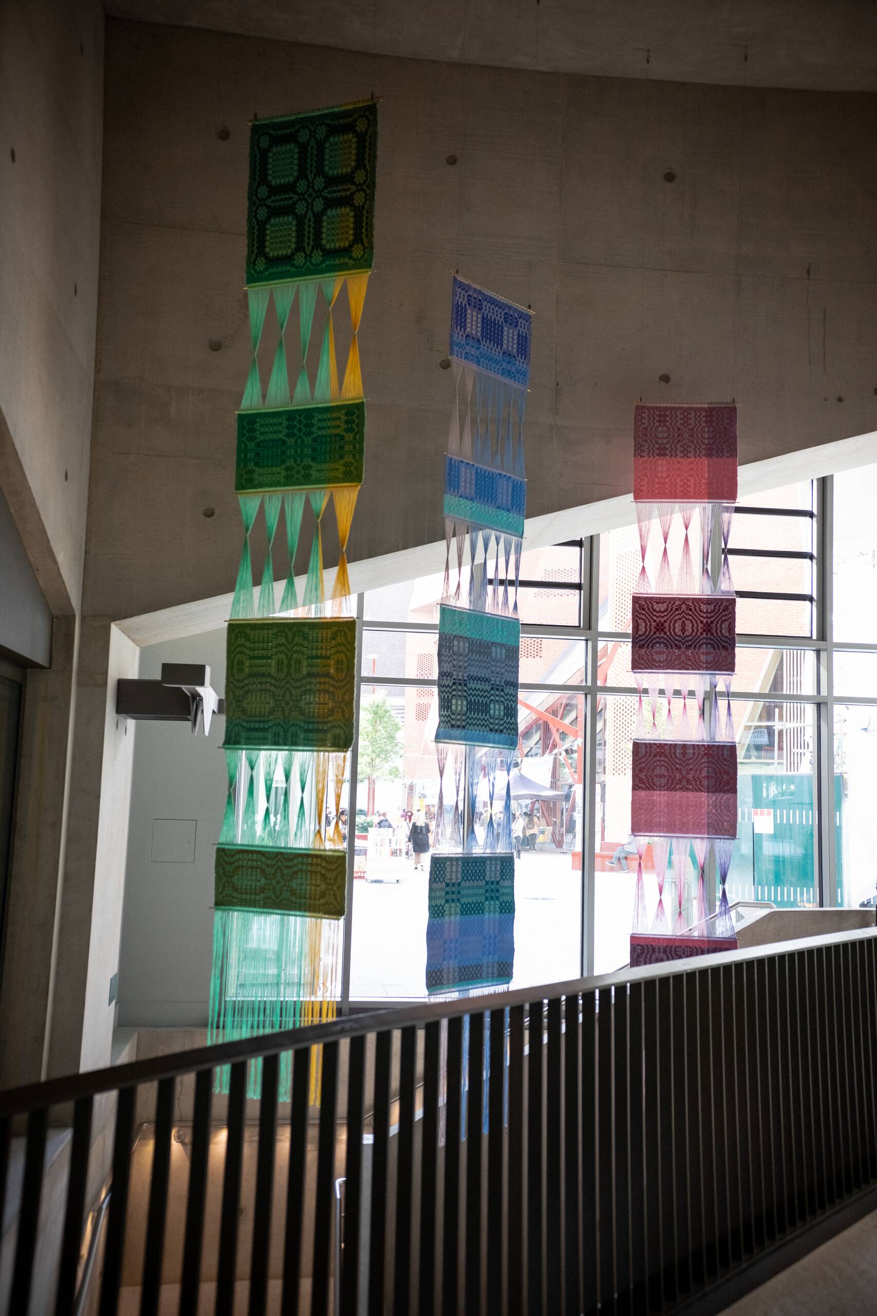 Interaction of pattern [systems of influence in red, green, & blue], Hand-woven cotton yarn, brass, aluminum (commissioned by Artiq, permanent installation at London School of Economics Marshall Building), 2022