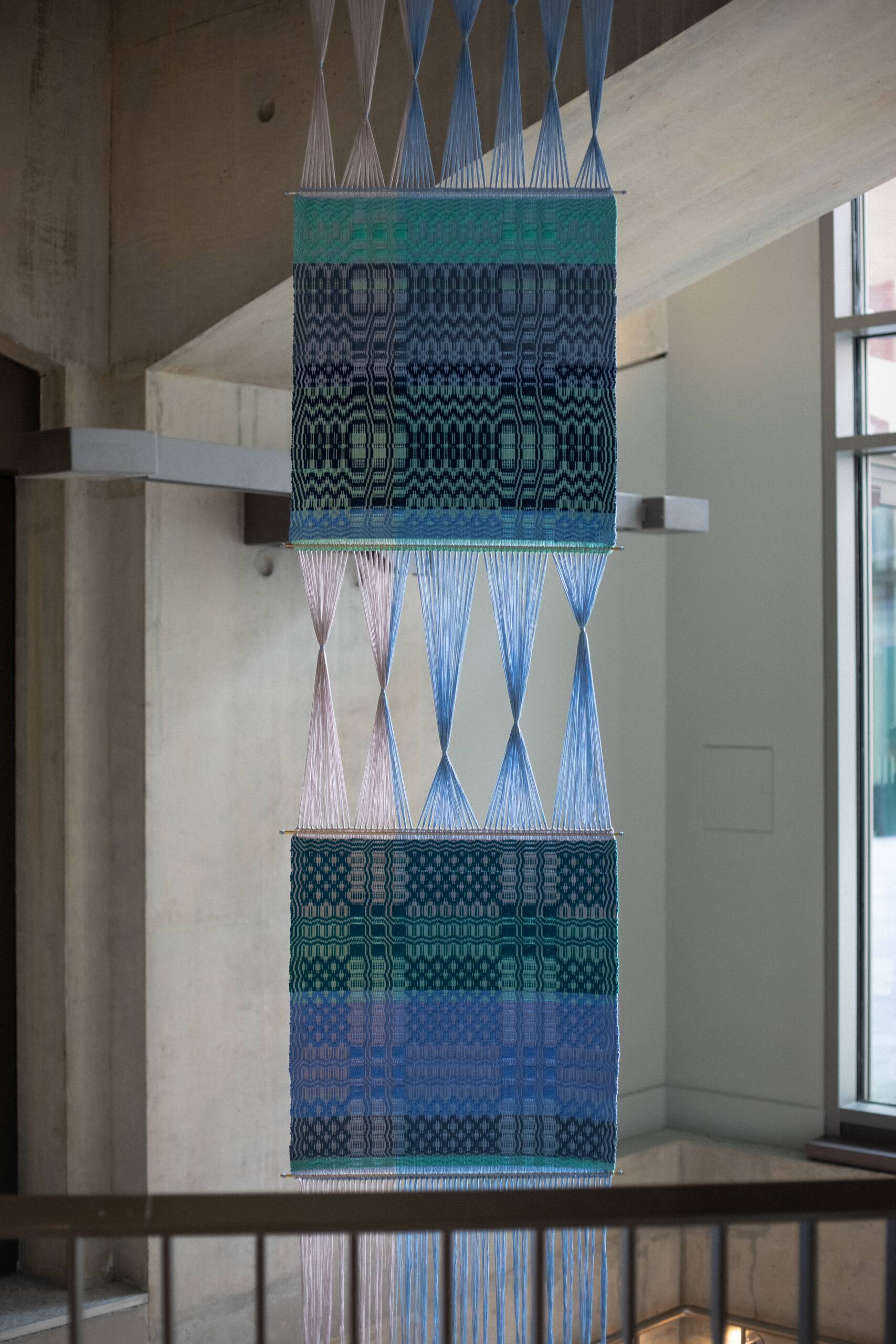 Interaction of pattern [systems of influence in red, green, & blue], Hand-woven cotton yarn, brass, aluminum (commissioned by Artiq, permanent installation at London School of Economics Marshall Building), 2022