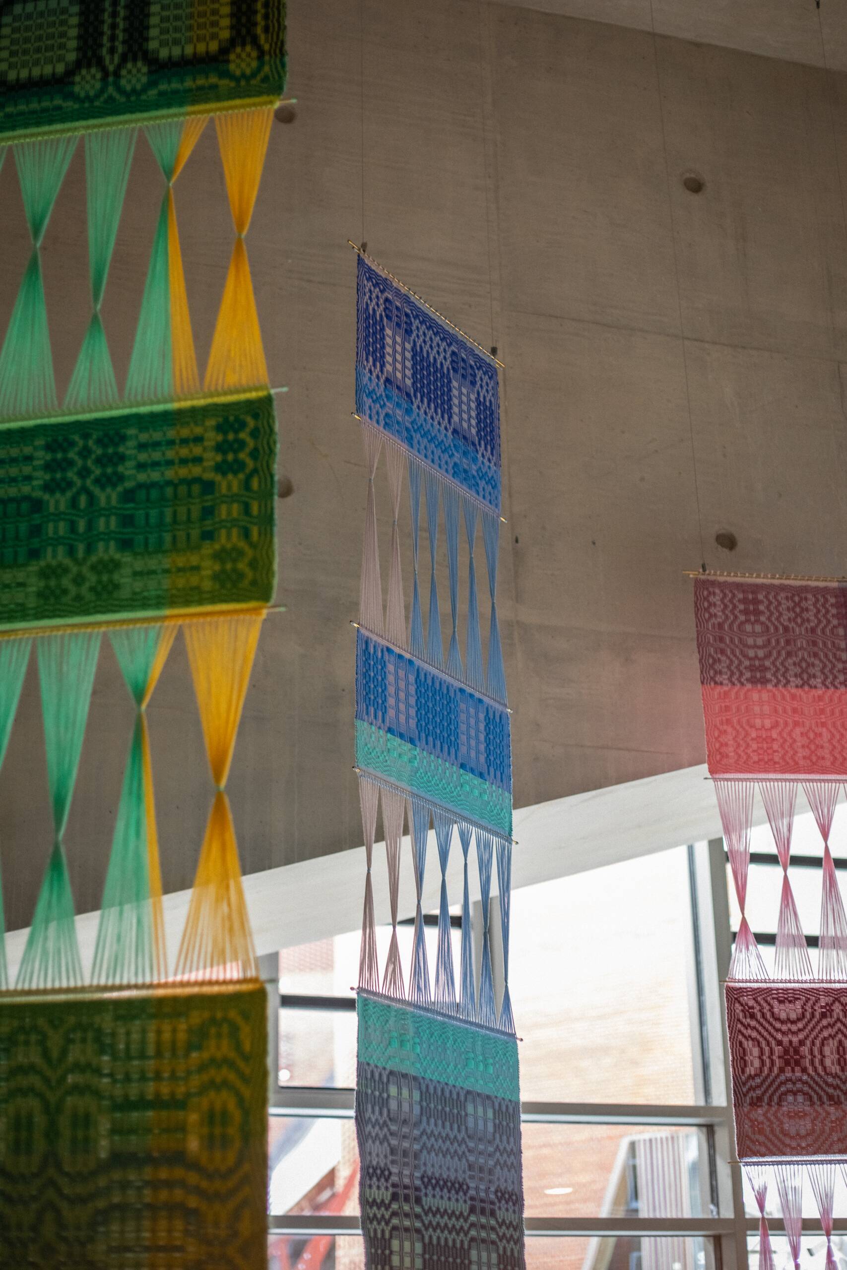 Interaction of pattern [systems of influence in red, green, & blue], Hand-woven cotton yarn, brass, aluminum (commissioned by Artiq, permanent installation at London School of Economics Marshall Building), 2022
